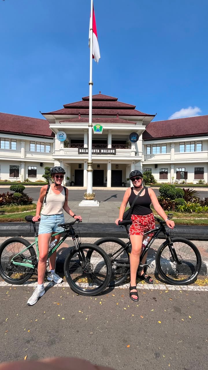 Travelers cycling through Malang City, exploring historic streets, local markets, colorful neighborhoods, and cultural landmarks on a guided city cycling tour."