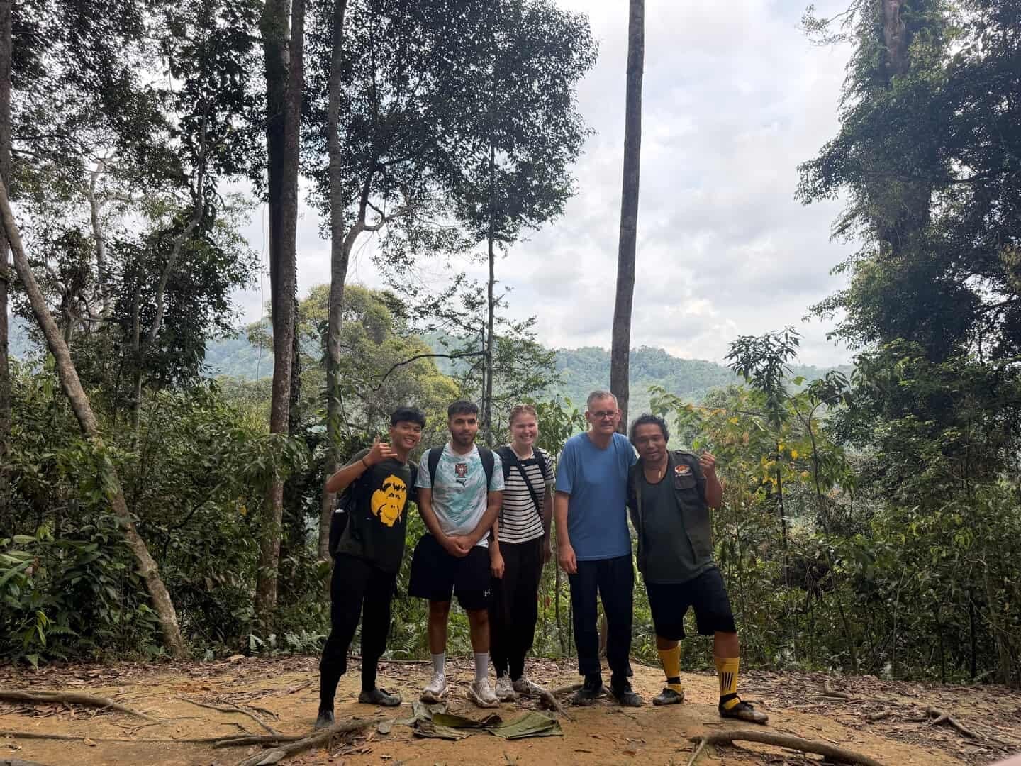 Hikers trekking through the Bukit Lawang rainforest during a 3 Days 2 Nights jungle adventure in Gunung Leuser National Park, Sumatra.