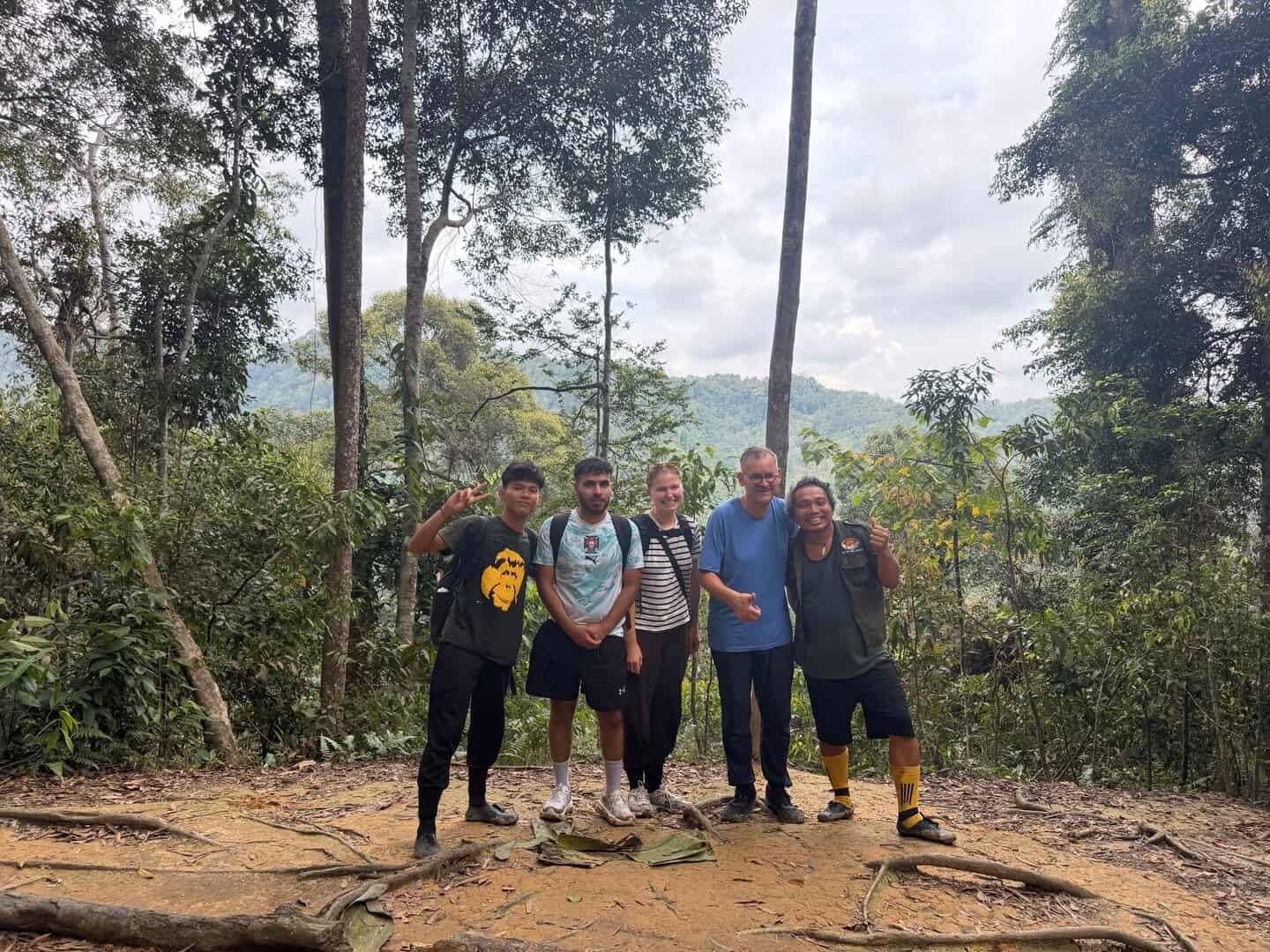 Hikers trekking through the Bukit Lawang rainforest during a 3 Days 2 Nights jungle adventure in Gunung Leuser National Park, Sumatra.