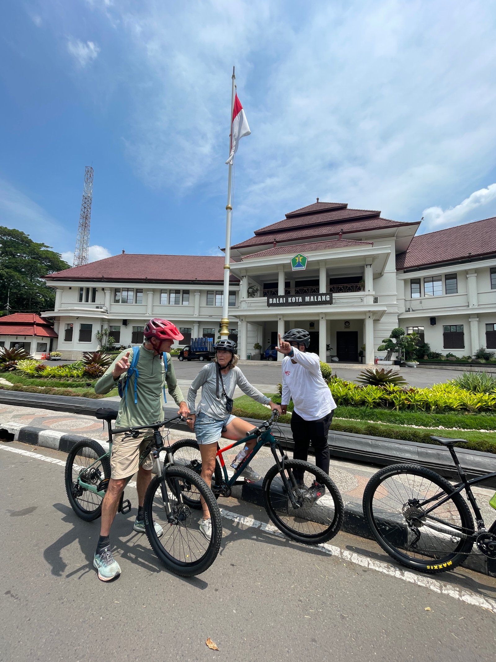 Travelers cycling through Malang City, exploring historic streets, local markets, colorful neighborhoods, and cultural landmarks on a guided city cycling tour."